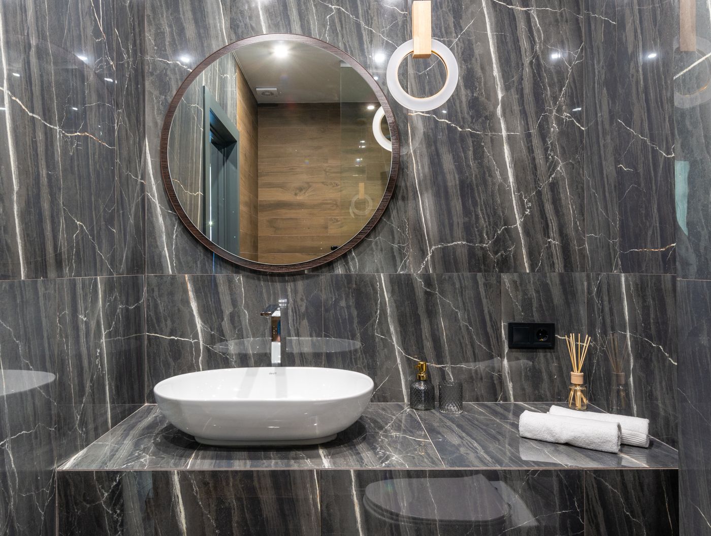 Marble washbasin counter with a round mirror